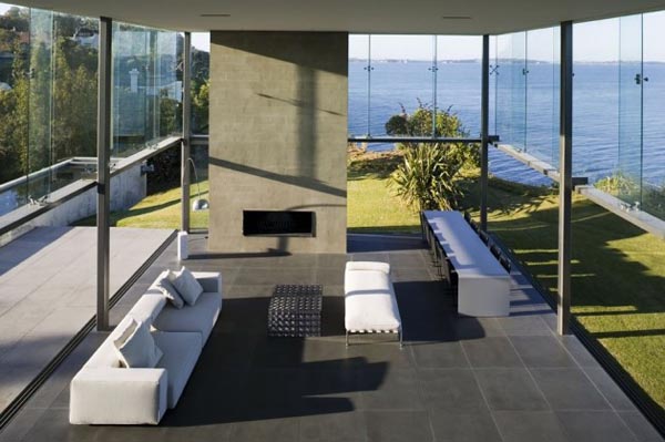Inside the Cliff House with huge glass fronts by Fearon Hay Architects in Auckland, New Zealand