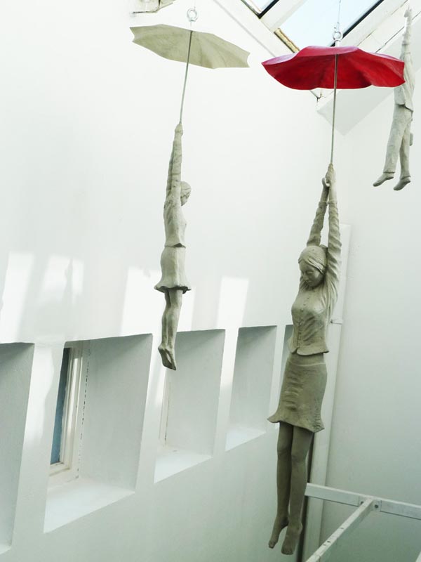 Cement Sculptures Dangling from Umbrellas