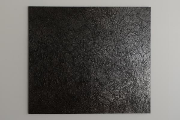 Artwork covered with black glue and polished by graphite