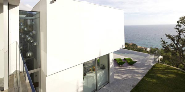 Modern architecture placed on a steep cliff overlooking the sea.