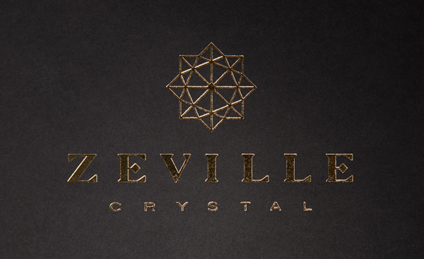 Zeville Crystal - embossed golden logo on black background