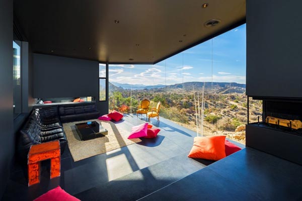 The living room of the house is characterized by modern interior design and a beautiful view of the landscape.
