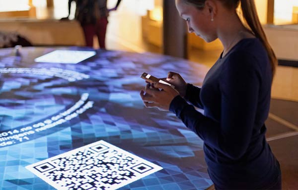 A visitor is scanning a QR code with a mobile phone to get further information.