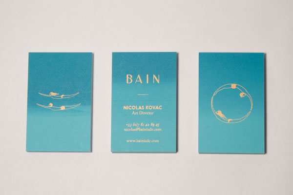 The blue version of the business cards with golden illustrations and lettering.