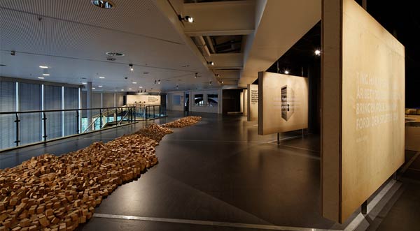 The wooden blocks serve as an analog haptic tools to trigger digital interactions within the exhibition.