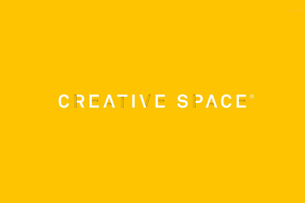 The Creative Space - logotype based on cut-out letterforms with a yellow background.