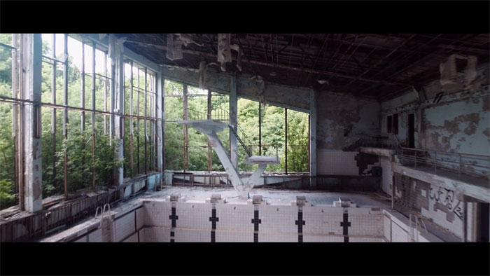 A dilapidated indoor swimming pool.