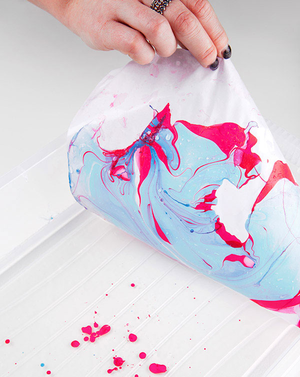 Colors and organic shapes created by swirling ink on water.