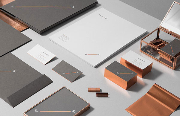 The complete brand identity for Vesha Law is based on a noble copper and silver finish.
