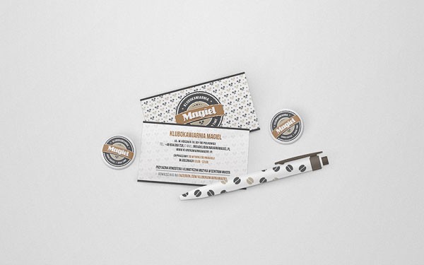 Promotional items - Business cards, buttons, and a ballpoint pen.