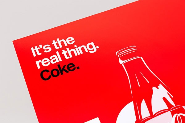 Detail view of the slogan: "It's the real thing. Coke."