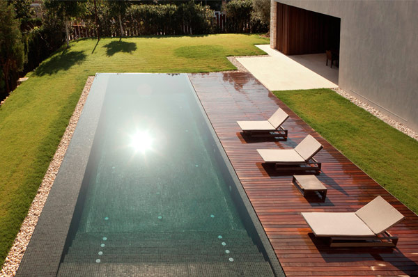 The generous pool invites to swim and relax.