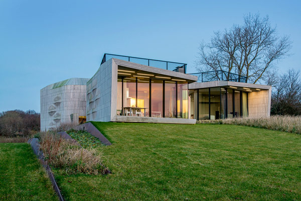 The W.I.N.D. house is surrounded by trees and sprawling grasslands.