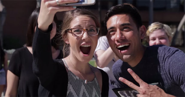 Enthusiastic people photograph him or take selfies with him Zach King.