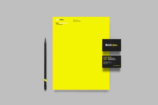 Stationery and business cards of a brand identity, which is essentially reduced to black and yellow colors.