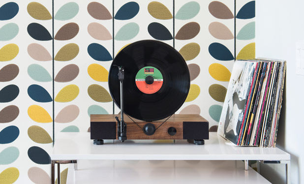 This high-performance vertical turntable with full-range stereo speakers is also a stylish design element for your home.
