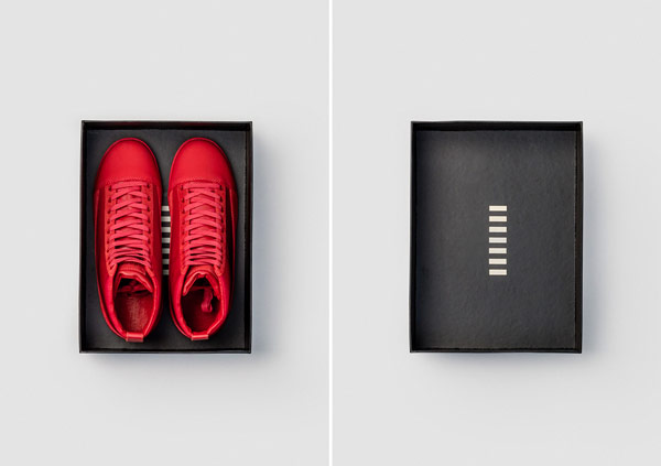 Red shoes in a black cardboard box.