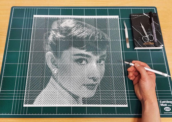The artist at work, Yoo Hyun carves a stunning paper portrait of Audrey Hepburn by hand.