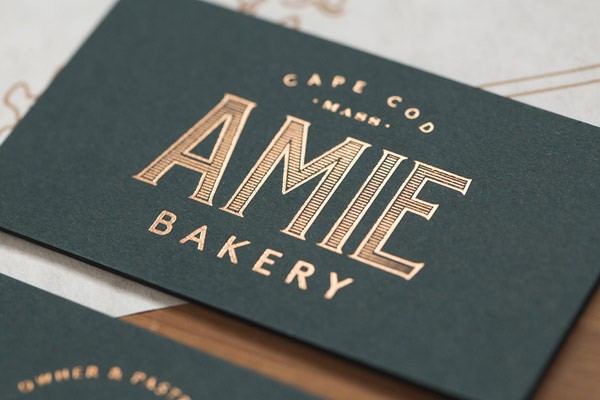 Business cards with golden logo print on the front.