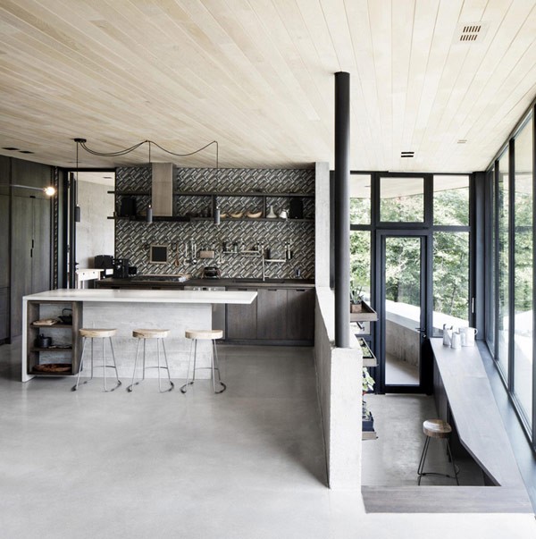 The bright and open kitchen design with windows down to the floor.