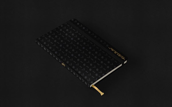 The black notebook has been designed with a pattern of icons on the cover.