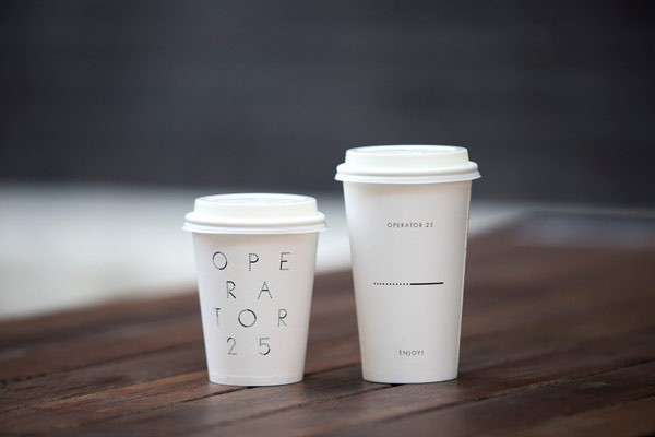 Operator 25 Cafe – white coffee mugs printed with the custom typeface for takeaway.