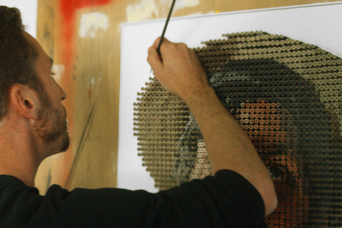 Andrew Myers hand paints each screw head.