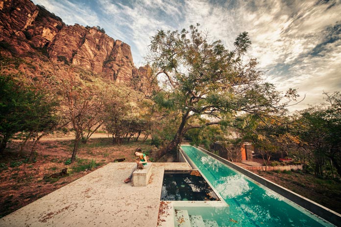 The pool is nestled in a natural environment.