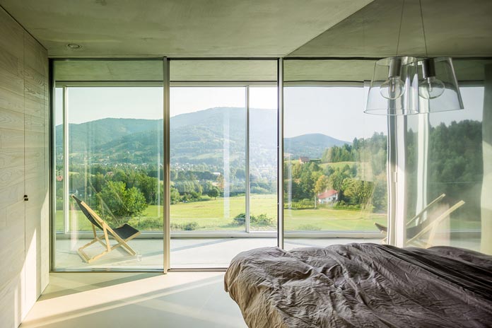 Bedroom with windows from floor to ceiling.