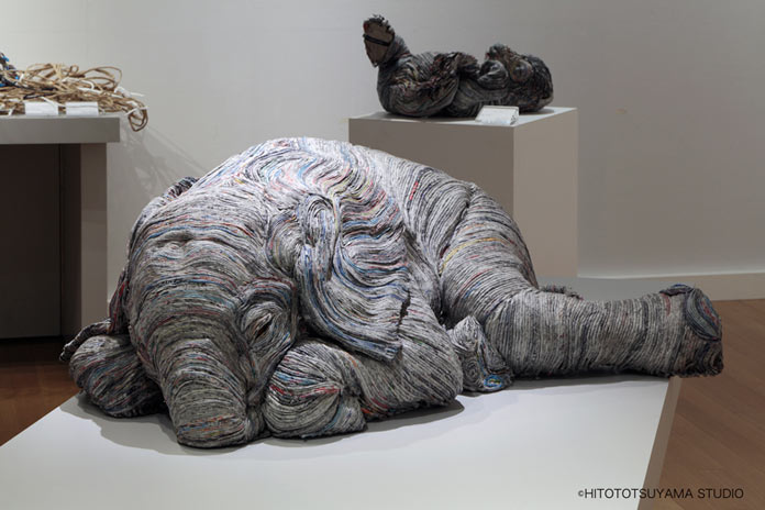 Elephant sculpture made from thousands of rolled newspapers.