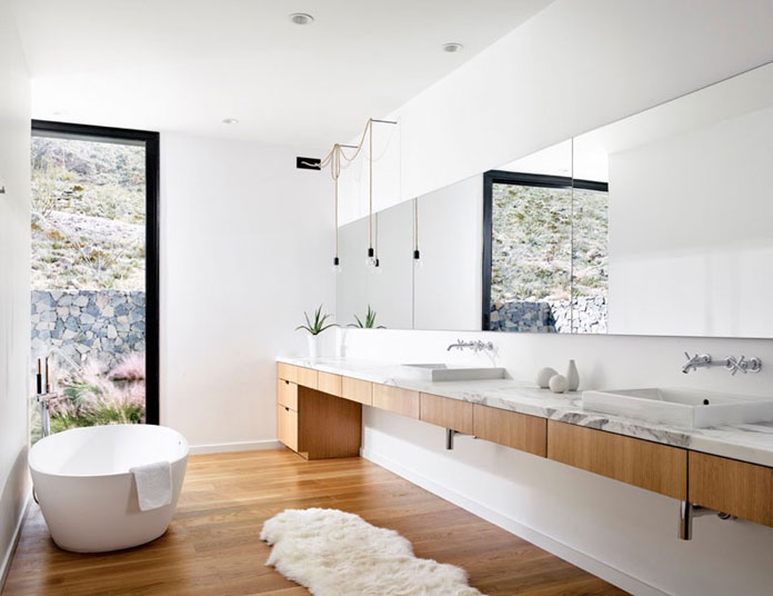 Modern white bathroom design with wood segments.