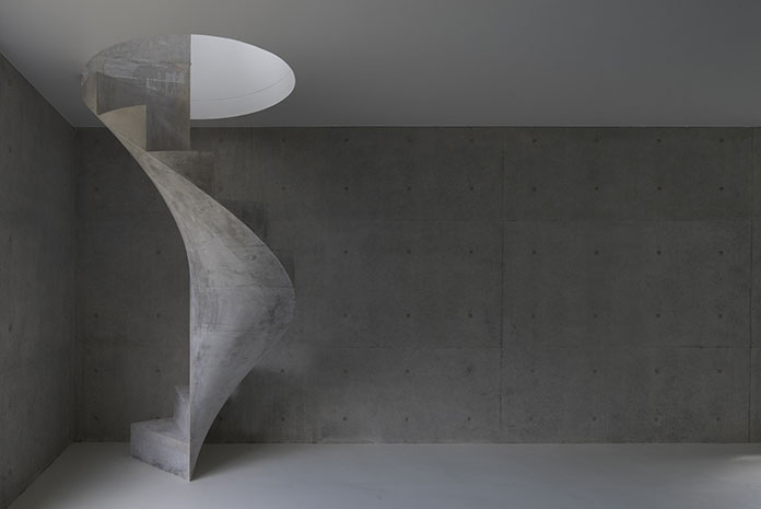 Concrete spiral staircase acts like a permanently installed sculpture.