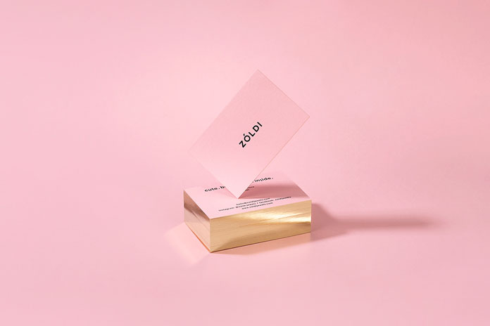 Pink business cards with golden edges.