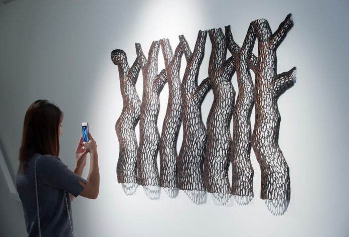 Sculptures created through spiraling branches, curves, and notches.