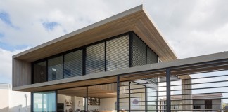 A modern family home designed by Julian Guthrie on a coastal property in Omaha, New Zealand.