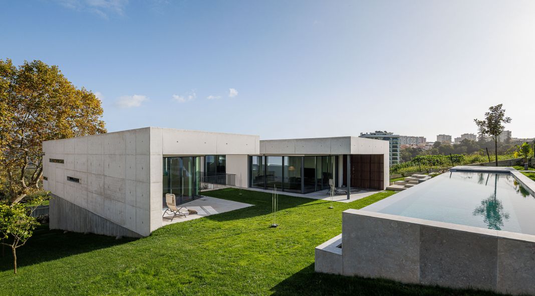 CAGE ATELIER designed a minimal concrete building that opens up timidly