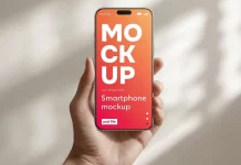 This Customizable iPhone Mockup PSD File Is the Smartphone Template Designers Actually Need A smartphone Photoshop mockup of a hand holding an iPhone in a daylight setting.